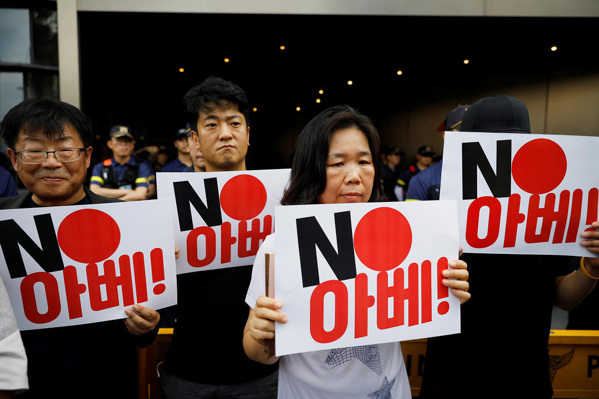 Protesters hold signs during an anti-Japan rally in front of the Japanese embassy in Seoul, South Korea,The sign reads "NO Abe". (Reuters Photo)