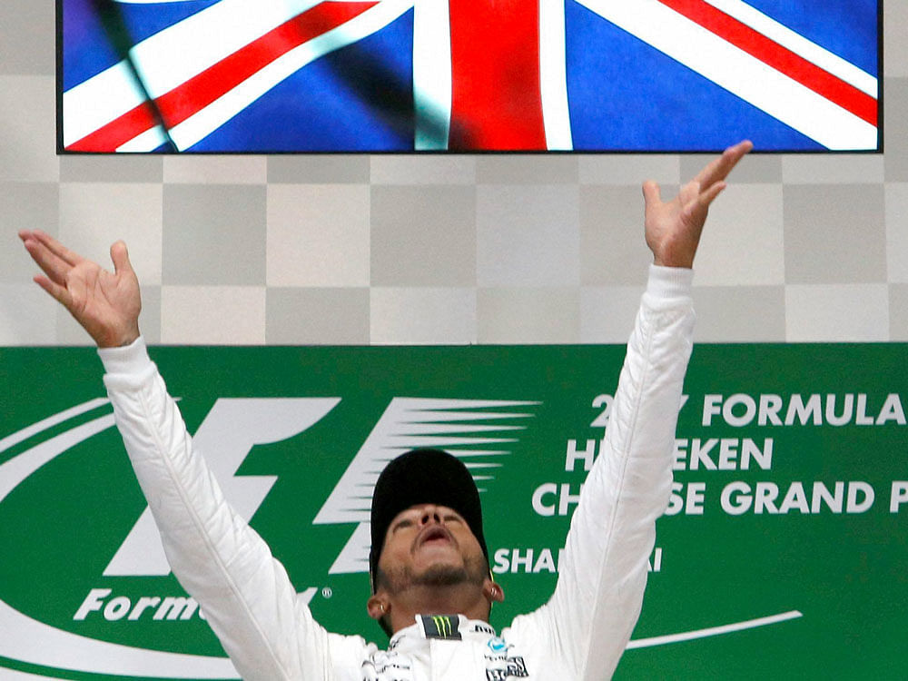 Mercedes driver Lewis Hamilton of Britain tosses his trophy into the air on the podium after winning the Chinese Formula One Grand Prix at the Shanghai International Circuit in Shanghai, China, Sunday, April 9, 2017. AP/ PTI