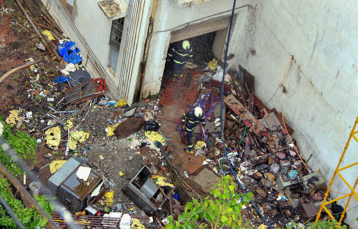 Debris seen scattered around as fire fighters conduct cooling operations a day after a fire broke out at the MTNL building in Bandra, Mumbai last week (PTI File Photo)