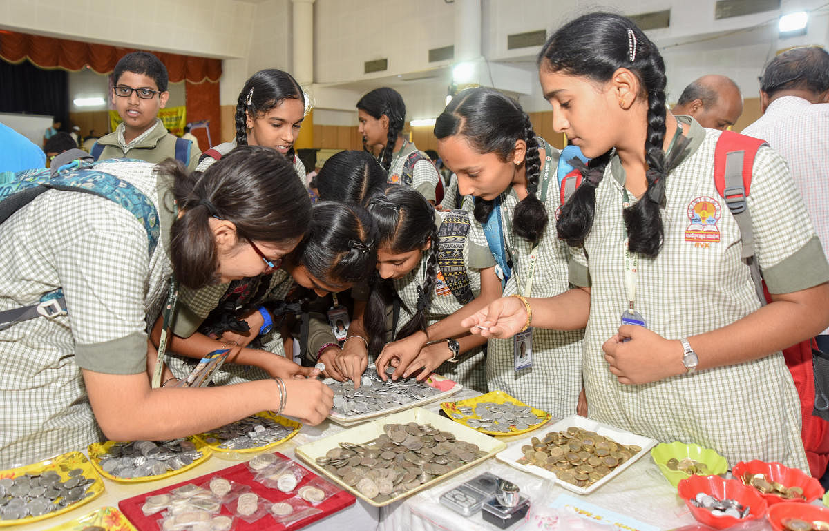 Glimpse of the past: Students viewing coins and other artefacts displayed at an exhibition at Karnataka Numismatic Society in Bengaluru. DH Photos/ Anup R Thippeswamy