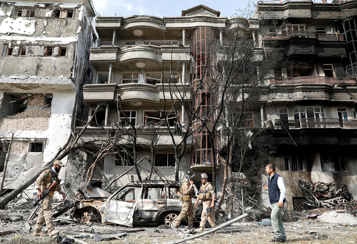 Afghan security forces inspect the site of an attack in Kabul, Afghanistan. (Reuters Photo)