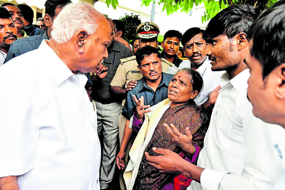 Chief Minister B S Yediyurappa interacts with people at his Dollars' Colony residence in Bengaluru on Saturday.