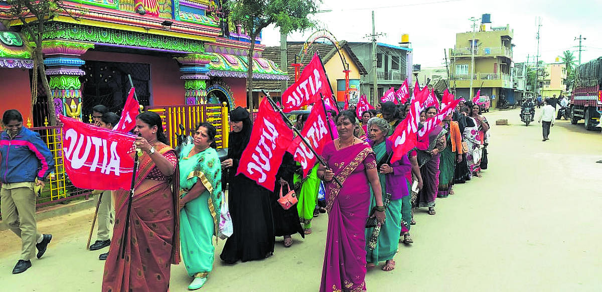 Akshara Dasoha workers take out a protest march in Chikkamagaluru on Saturday.