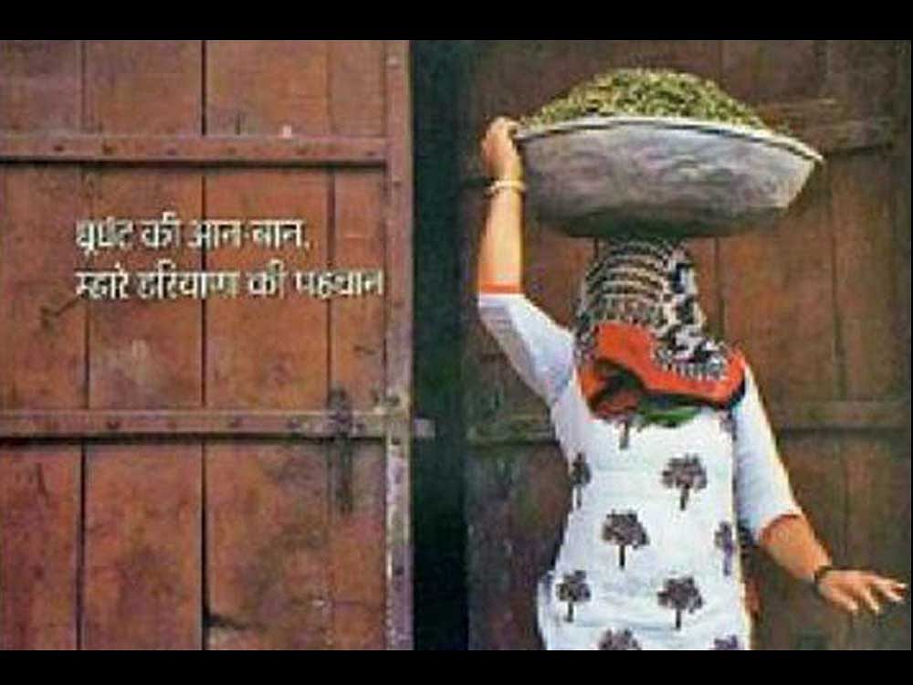 The woman's face can be seen covered with a 'ghoongat'. The woman is seen carrying cattle feed on her head, even as the caption reads:'Ghoongat ki aan-baan, mahra Haryana ki pechchan (pride of the veil is the identity of my Haryana'. Photo via twitter.