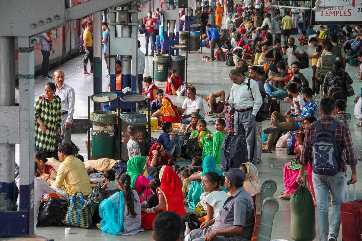 Tourists and Amarnath Yatris wait at Jammu Railway Station to leave for their homes after the J & K government issued a security advisory asking them to curtail their stay in the state (PTI Photo)