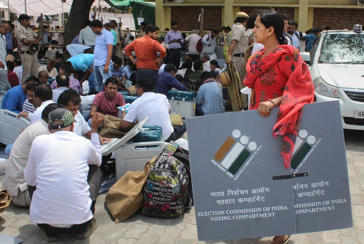 Gurugram: Polling officials collect EVMs, VVPAT and other election materials ahead of the sixth phase of Lok Sabha polls, in Gurugram, Saturday, May 11, 2019. (PTI Photo) (PTI5_11_2019_000098A)