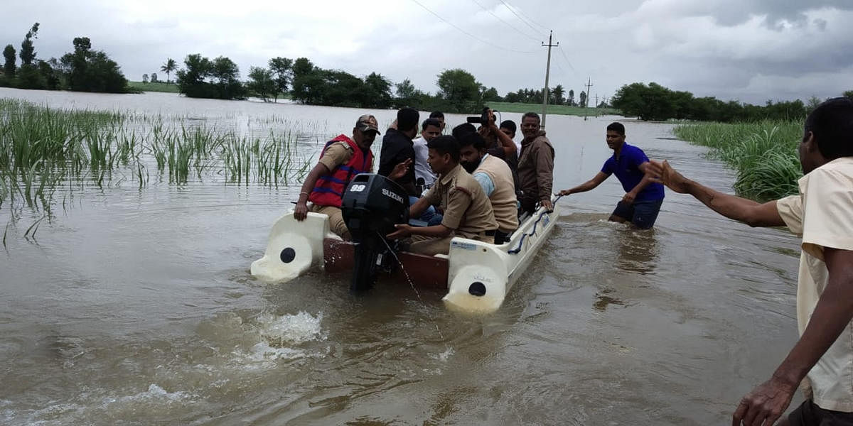 A boat pressed into service for shifting peopled trapped in floods in Manjri village of Chikkodi taluk, Belagavi district, on Saturday. DH Photo
