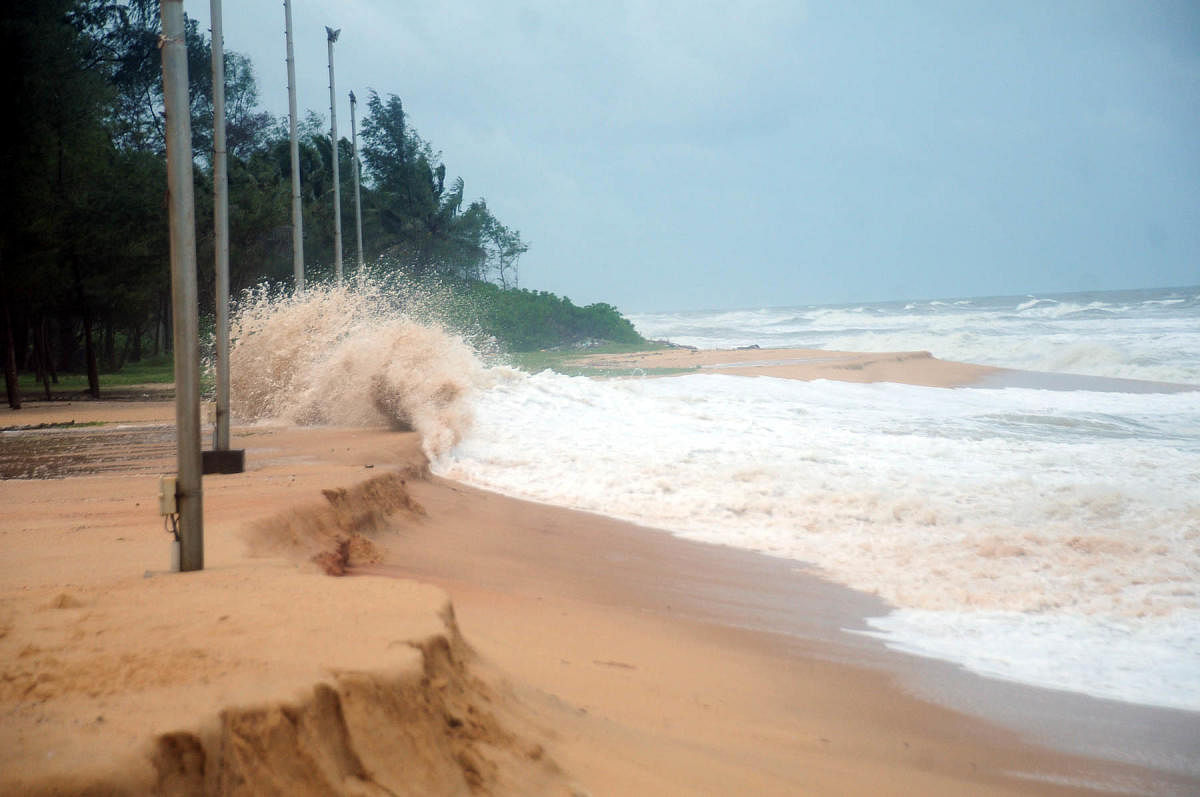 Electricity poles face the threat of being washed away due to sea erosion at Padubidri beach.