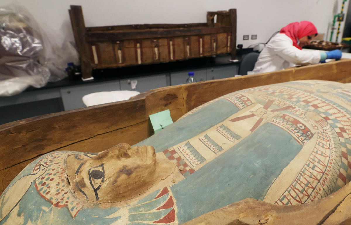 An archaeologist works next to the sarcophagus of Egypt's boy-king Tutankhamun at the Grand Egyptian Museum in Giza (Reuters Photo)