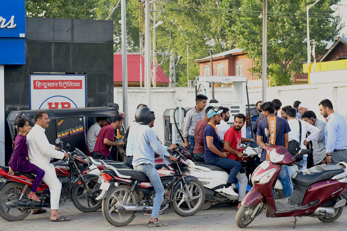eople line up outside a petrol pump in Srinagar, Friday, Aug. 2, 2019. An advisory asking tourists and Amar Nath Yatris to cut short their stay in Kashmir was put out by the army. (PTI Photo)
