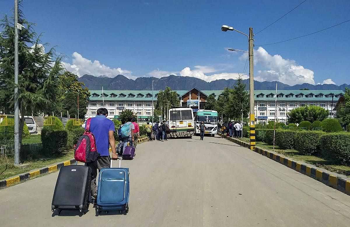National Institute of Technology students leave the Valley after the institute decided to suspend classes amid panic over troop build-up in Srinagar on Saturday. PTI