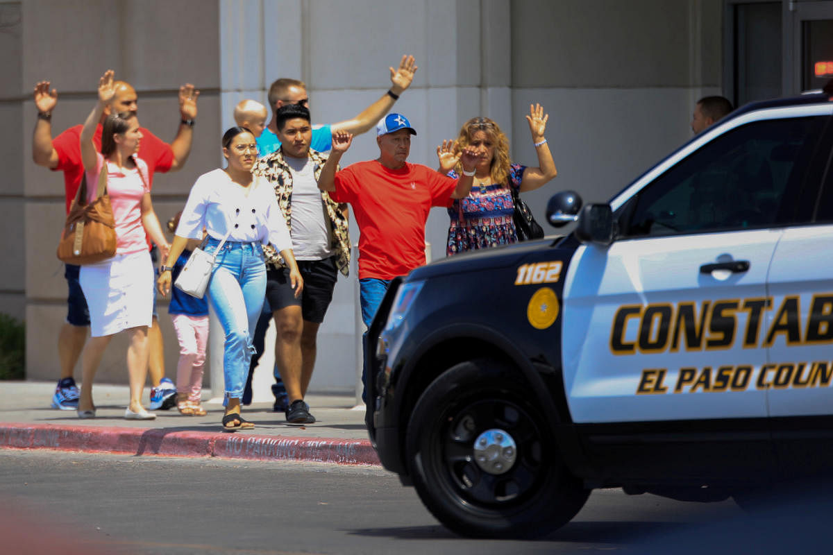 Shoppers exit with their hands up after a mass shooting at a Walmart in El Paso, Texas, U.S. August 3, 2019. REUTERS/Jorge Salgado NO RESALES. NO ARCHIVES. TPX IMAGES OF THE DAY