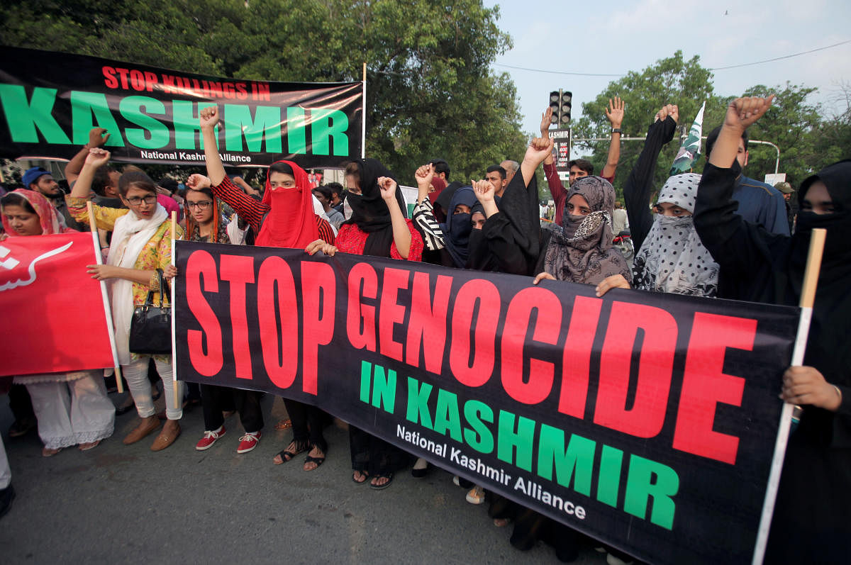 People hold banners and chant slogans during a rally in solidarity with the people of Kashmir, in Lahore (Reuters Photo)