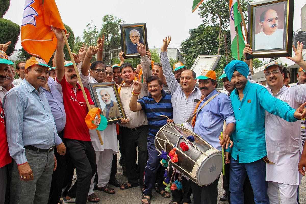 BJP workers celebrate government decision to revoke Article 370 that gave special status to Jammu and Kashmir and a separate bill to bifurcate the state into two separate union territories of Jammu and Kashmir and Ladakh. PTI photo