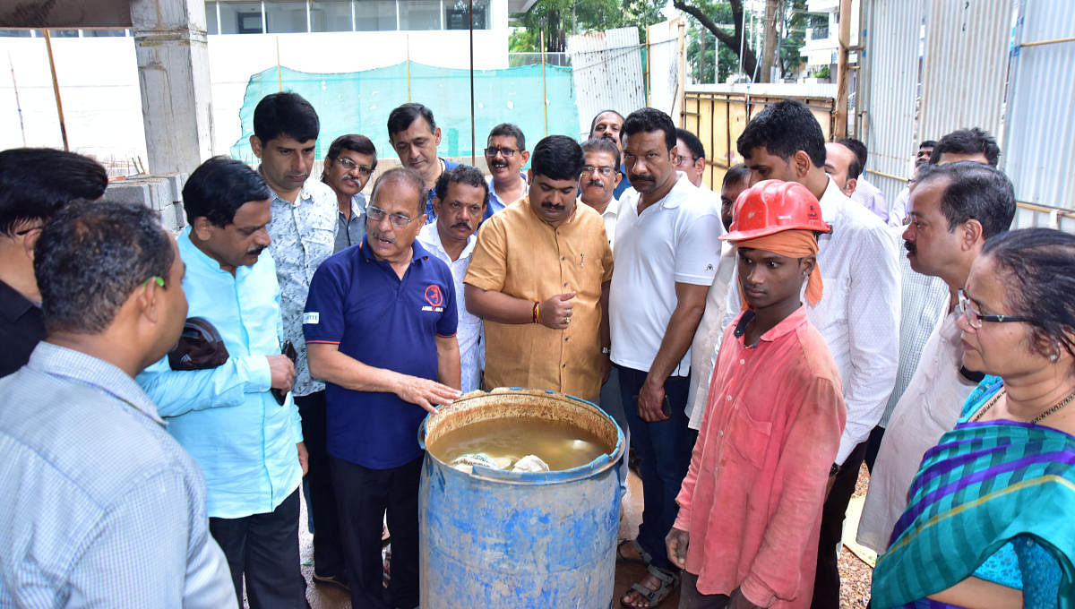 Mangalore City South MLA D Vedavyas Kamath along with volunteers creates awareness among construction workers on breeding of mosquitoes in stagnant water at Mannagudda, in Mangaluru. DH Photo