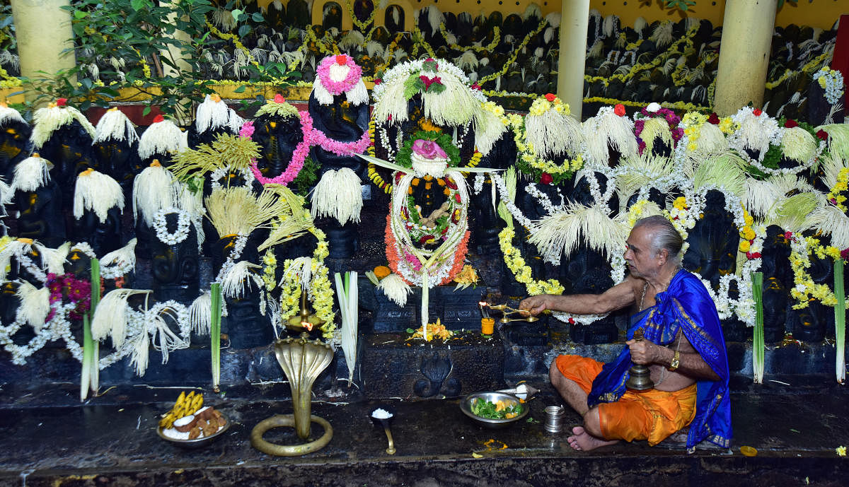 A priest performs puja on account of Nagara Panchami at Kudupu Shree Anantha Padmanabha Temple, on the outskirts of Mangaluru, on Monday.