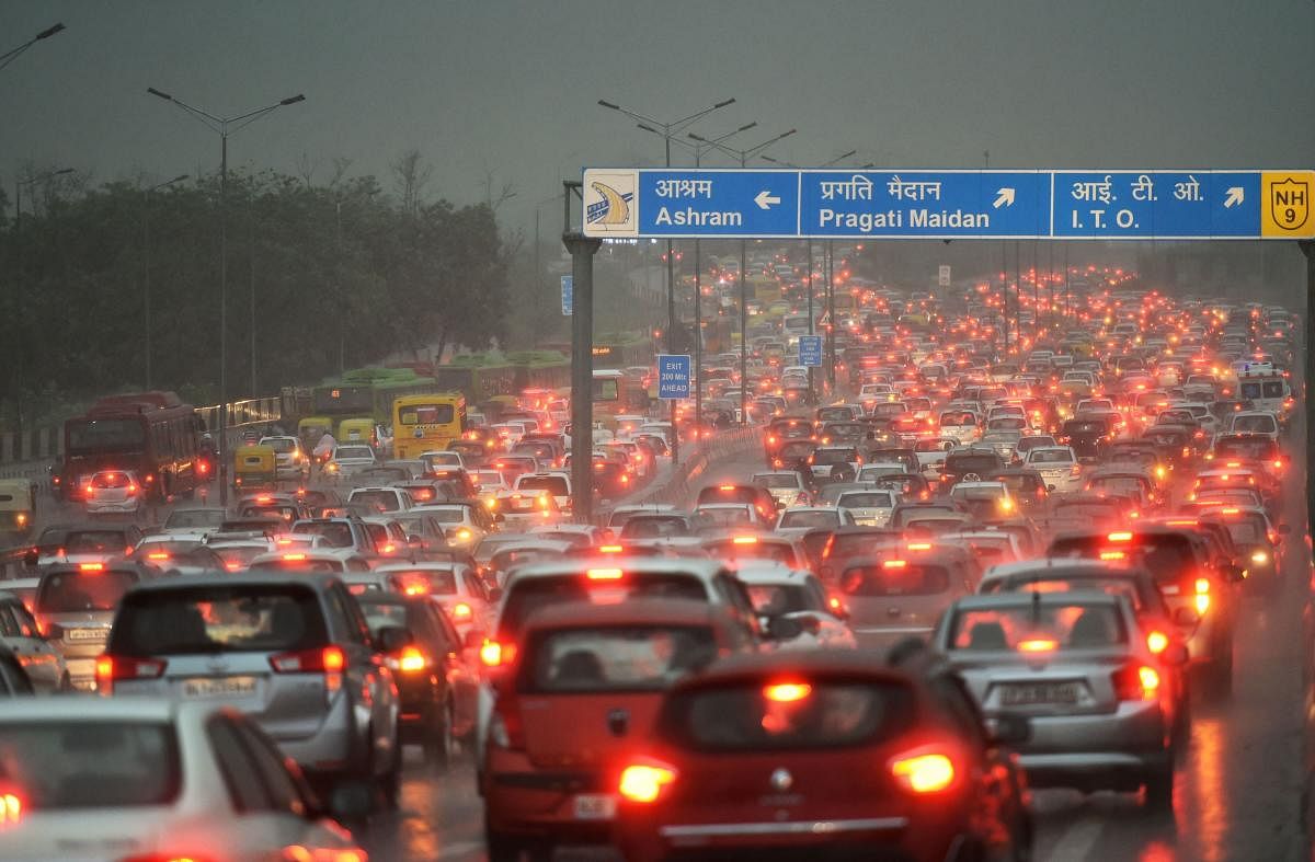 A view of the traffic jam at NH-24 during a heavy downpour, in New Delhi on Tuesday. (PTI Photo)
