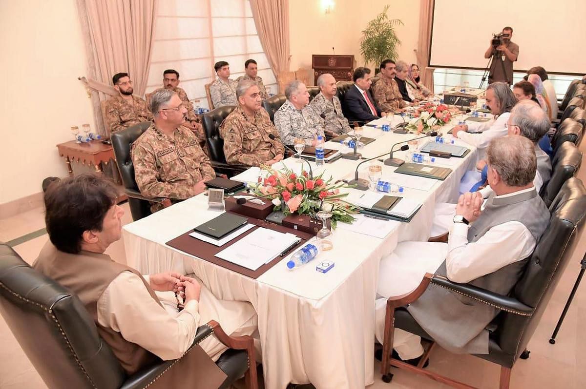 In this handout picture released by Press Information Department (PID) on August 4, 2019, Pakistan Prime Minister Imran Khan (L) chairs the National Security Committee meeting in Islamabad. (AFP PHOTO / PID)