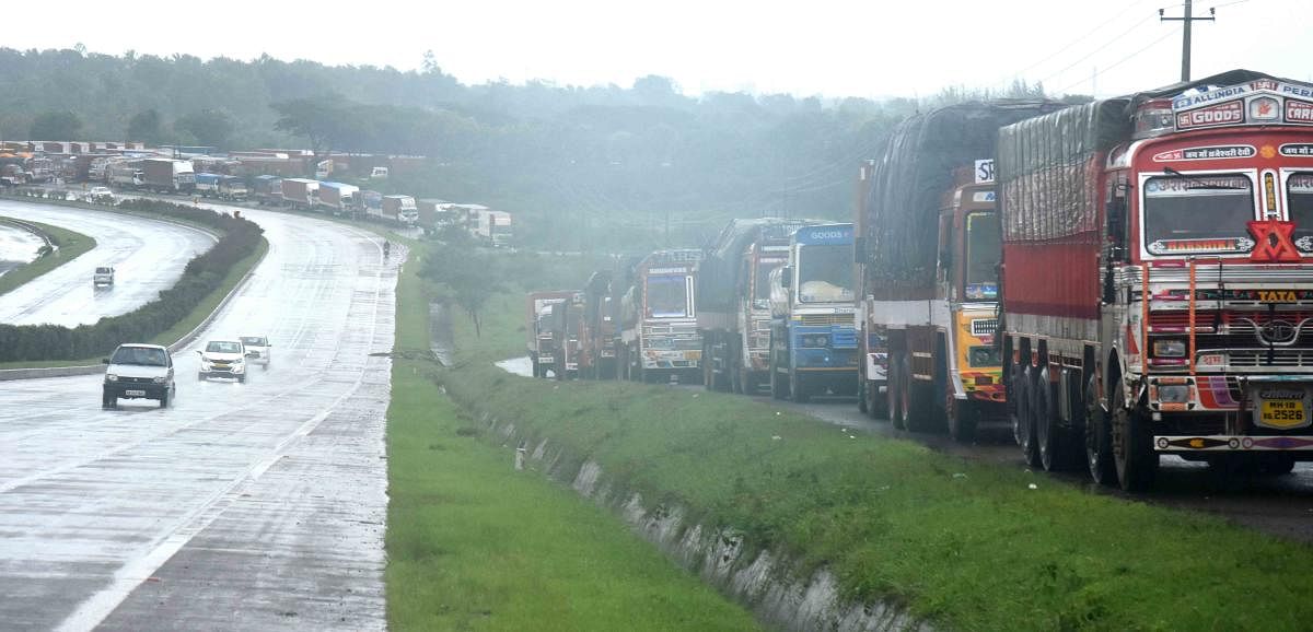 Trucks stranded near at Belur near Dharwad on National Highway-4 as following ban on movement of vehicles from Kolhapur, on Tuesday. DH Photo