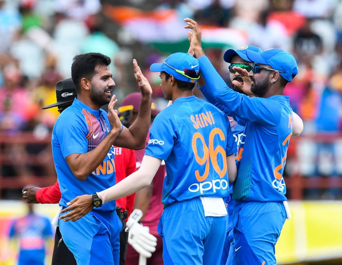 Indian pacer Deepak Chahar (left) celebrates with team-mates after dismissing West Indies opener Sunil Narine in the third T20I match in Guyana on Tuesday. AFP
