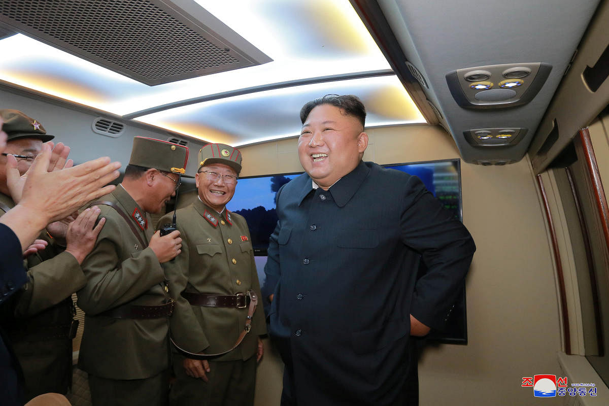 North Korean leader Kim Jong Un smiles as he guides missile testing at an unidentified location in North Korea, in this undated image provided by KCNA on August 7, 2019. (KCNA via REUTERS)