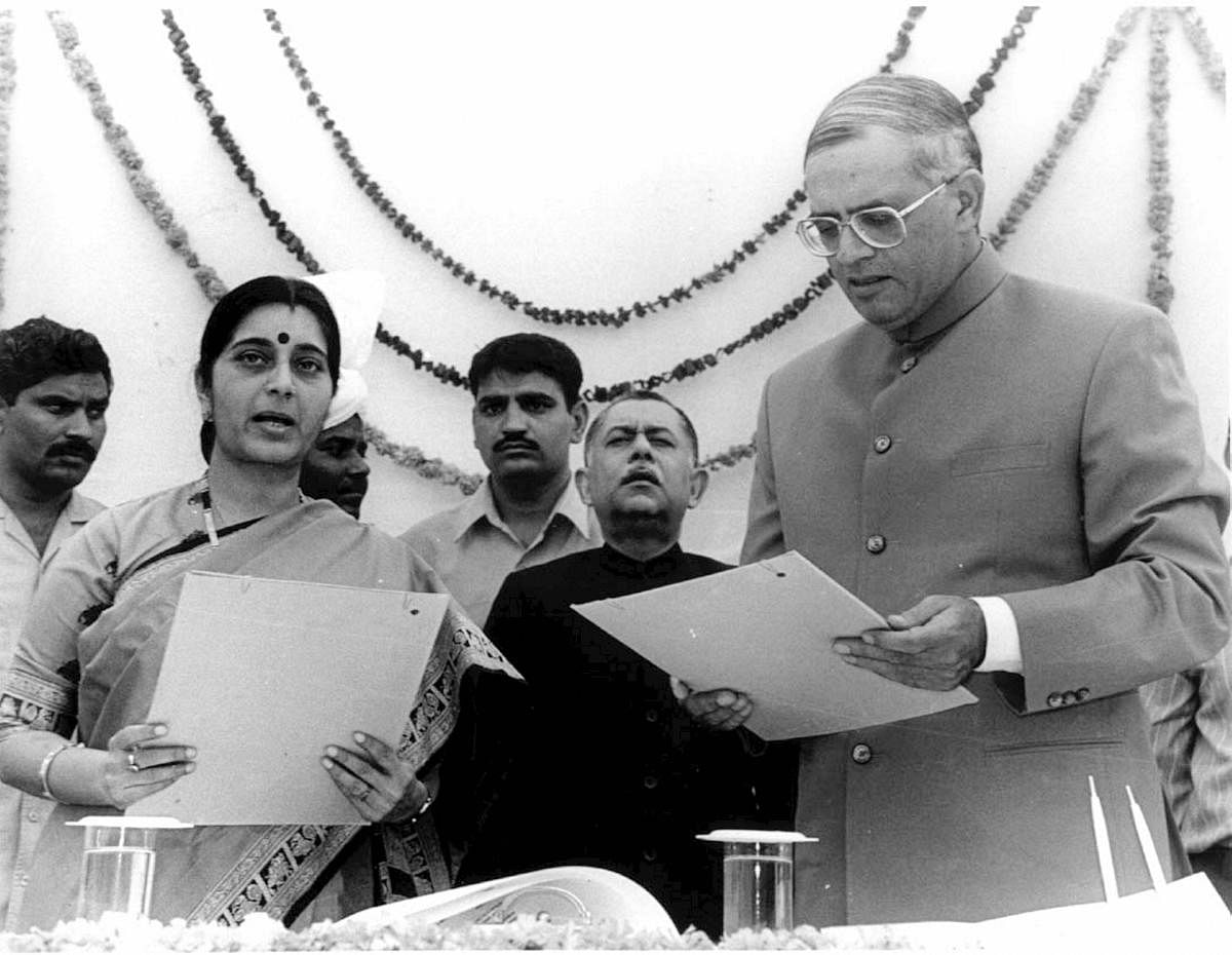 In this December 10, 1998 file photo, is seen Sushma Swaraj being sworn in as chief minister of Delhi by then Lt. Governor Vijay Kapoor at Raj Bhavan in New Delhi. (PTI File Photo)