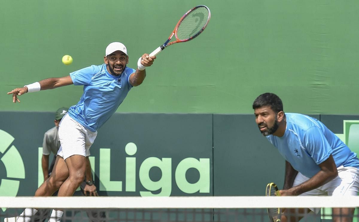 India's tennis players Divij Sharan and Rohan Bopanna in action against Italy's Matteo Berrettini and Simone Bolelli in the men's doubles match at the Davis Cup 2019 qualifier at South Club in Kolkata. (PTI Photo)