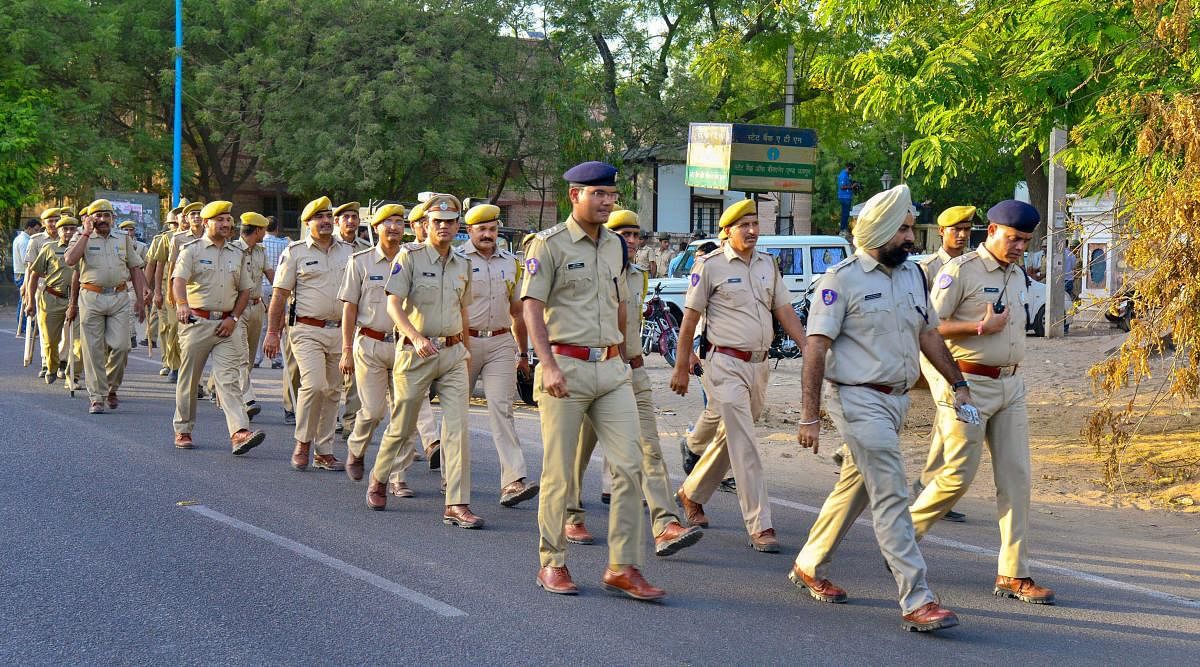 Police personnel march at Jodhpur Central Jail road as part of security arrangements, ahead of the court's verdict on Asaram sexual assault case, on Tuesday. (PTI Photo)