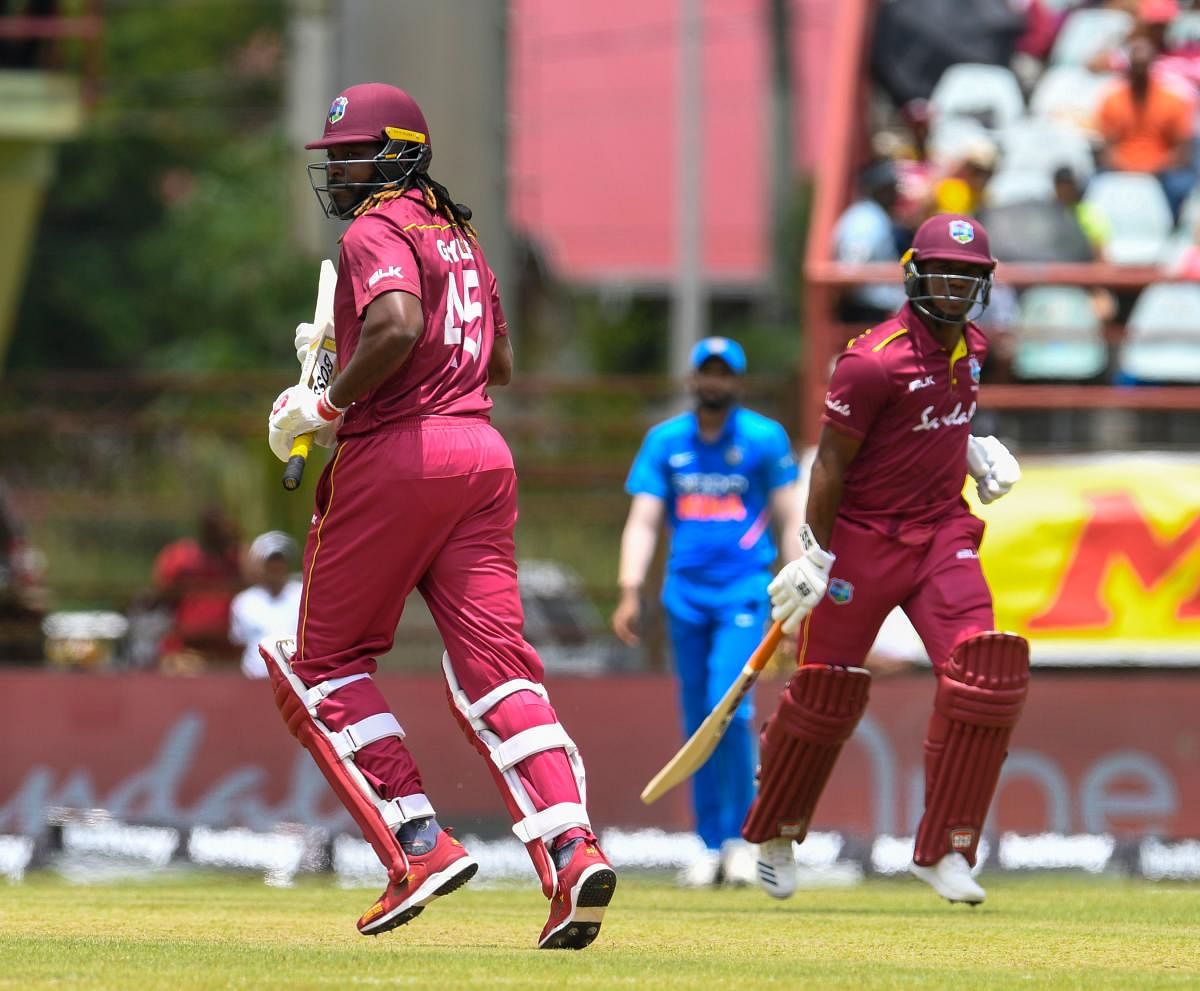 Chris Gayle (L) and Evin Lewis (R) of West Indies run during the 1st ODI match between West Indies and India at Guyana National Stadium in Providence, Guyana. AFP Photo