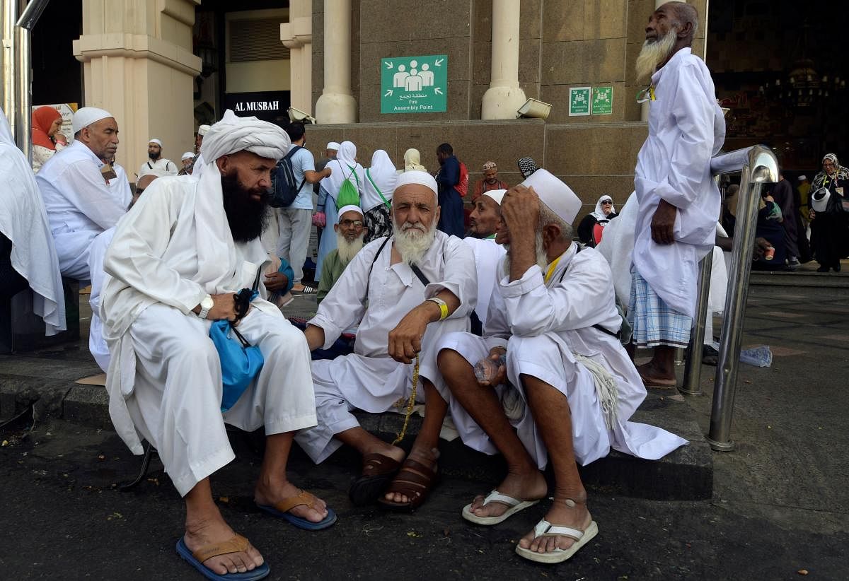 Mulism pilgrims wait for prayers at the Grand Mosque in Saudi Arabia's holy city of Mecca, prior to the start of the annual Hajj pilgrimage in the holy city. Photo credit: AFP