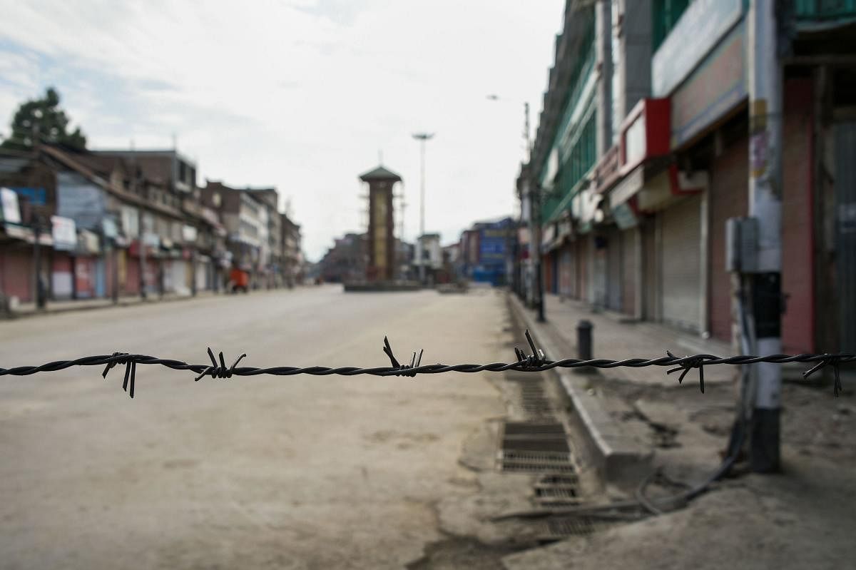 A view of a deserted street during restrictions at Lal Chowk in Srinagar. (PTI Photo/S. Irfan)