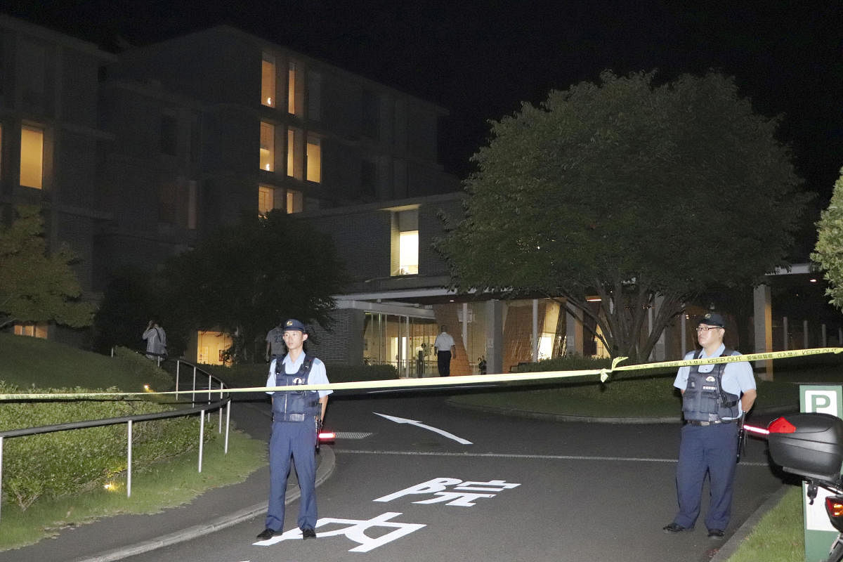 Policemen stand guard in front of a hospital where a knife-wielding man stabbed three nurses and a policeman in Shikokuchuo. Reuters Photo