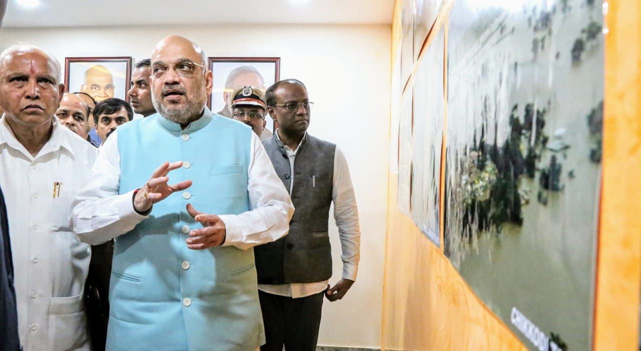 Karnataka Chief Minister  B S Yediyurappa and Union Home Minister Amit Shah being given information of flood situation in Belagavi district at the airport on Sunday