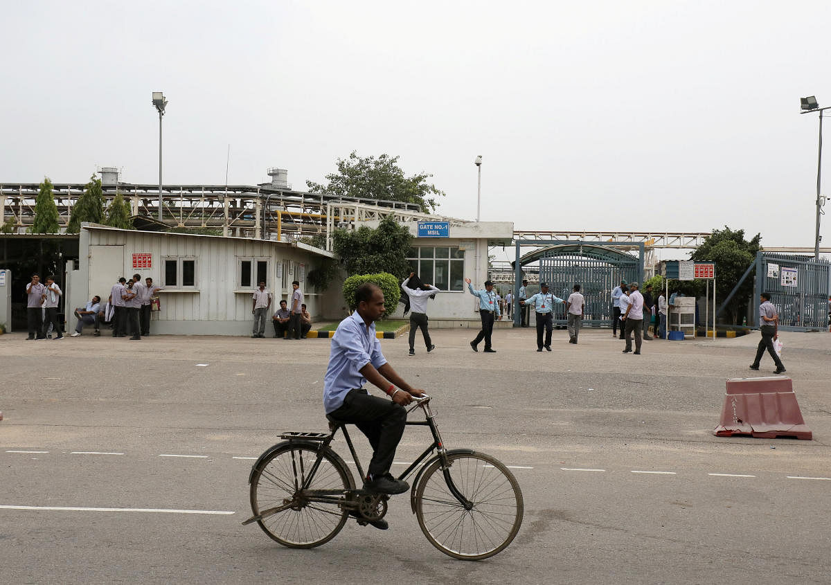 A man rides a bicycle past a Maruti Suzuki India Ltd. manufacturing plant in Manesar in the northern state of Haryana. Reuters file photo for representation. 