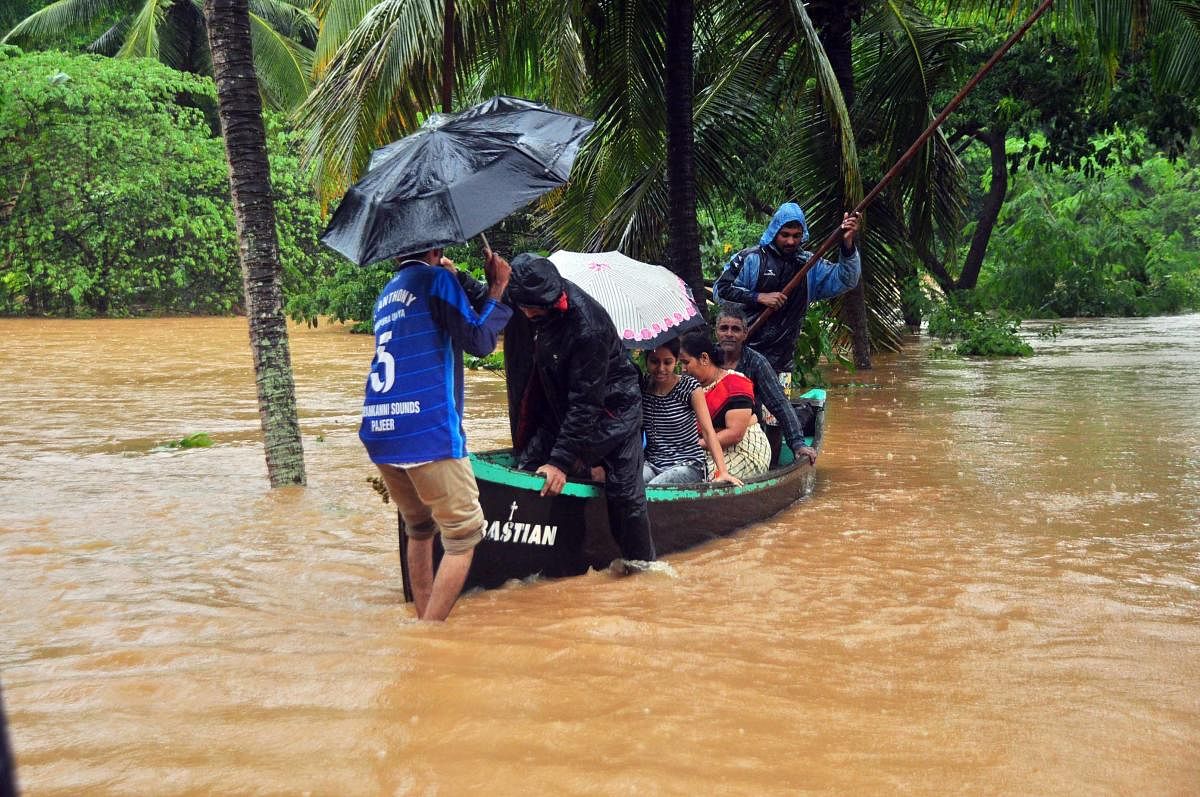 Flood victims rescued in a boat at Ranipura Uliya.
