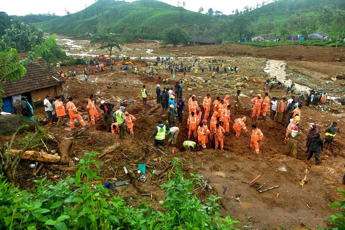 Volunteers, local residents and members of National Disaster Response Force (NDRF) search for survivors in the debris left by a slandslide at Puthumala at Meppadi in the Wayanad district,Kerala. AFP photo