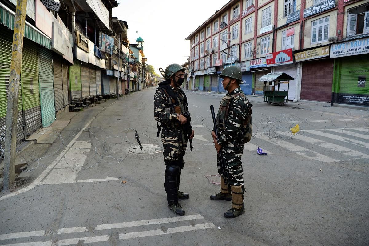 Security personnel stand guard on a street in Srinagar as widespread restrictions on movement and a telecommunications blackout remained in place after the Union government stripped Jammu and Kashmir of its autonomy. AFP