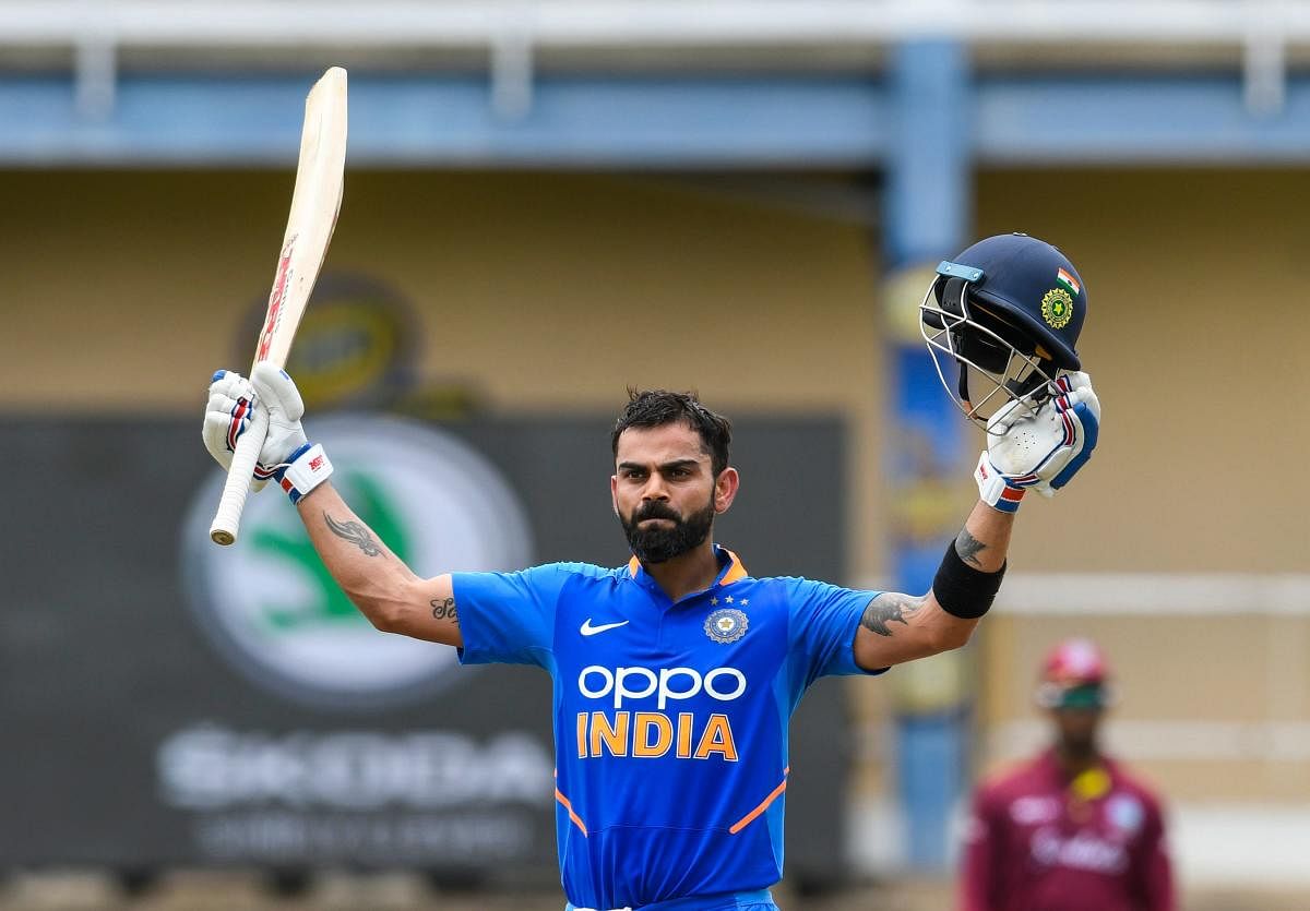 Virat Kohli of India celebrates his century (100 runs) during the 2nd ODI match between West Indies and India at Queens Park Oval in Port of Spain, Trinidad and Tobago. AFP photo