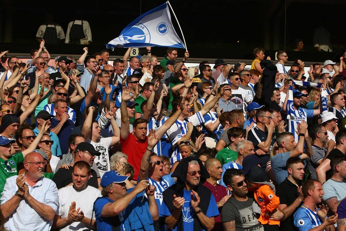 Brighton fans cheer at the end of the English Premier League football match between Wolverhampton Wanderers and Brighton and Hove Albion at the Molineux Stadium in Wolverhampton, central England. (AFP File Photo)