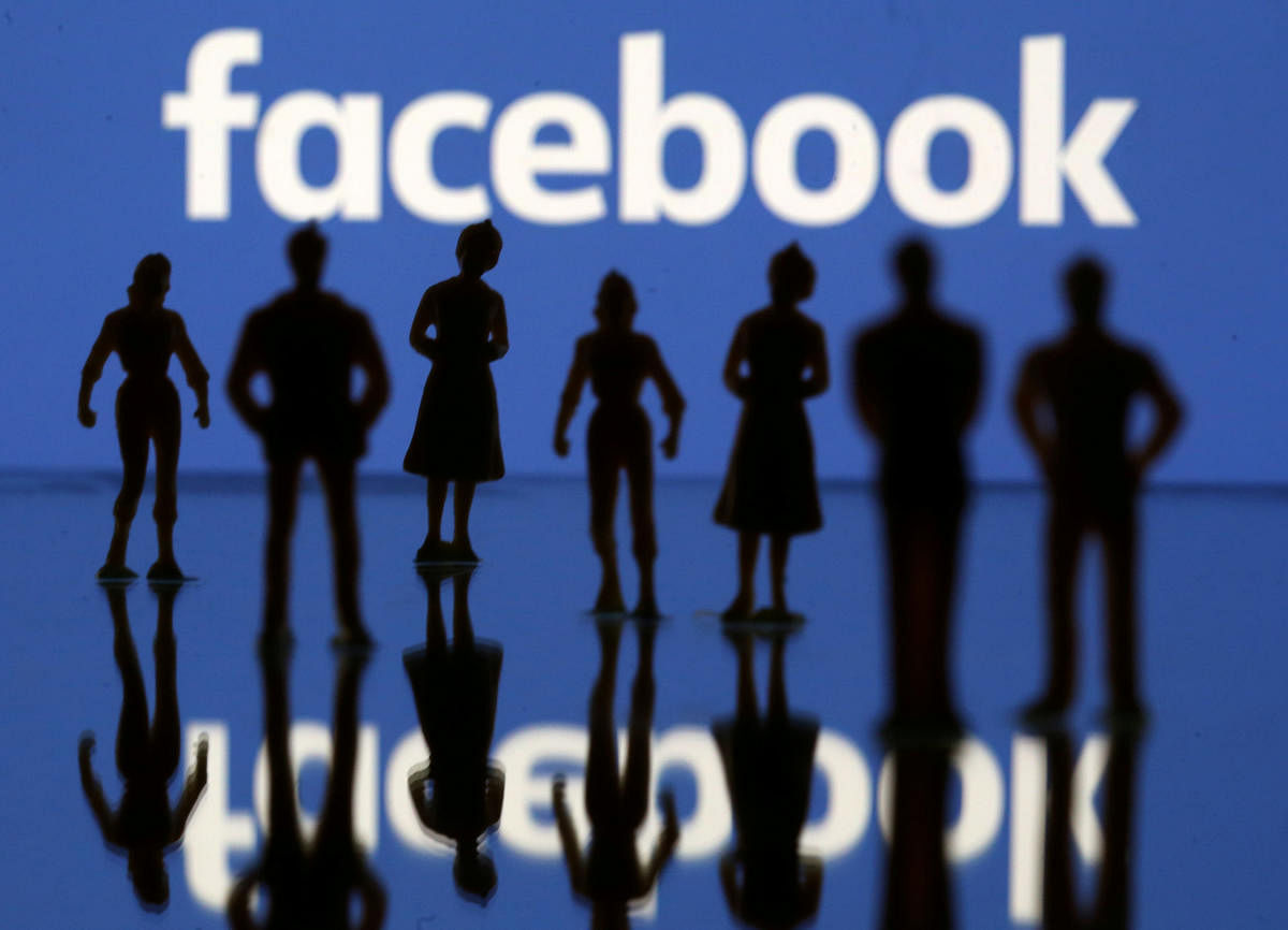 Small toy figures are seen in front of the Facebook logo in this illustration picture, April 8, 2019. (REUTERS File Photo)