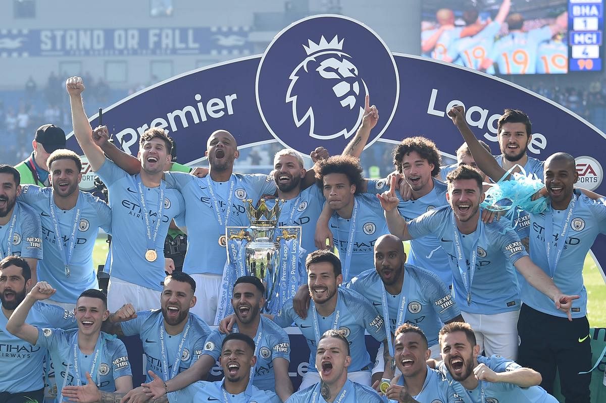 Manchester City players celebrate with the Premier League trophy on Sunday. AFP
