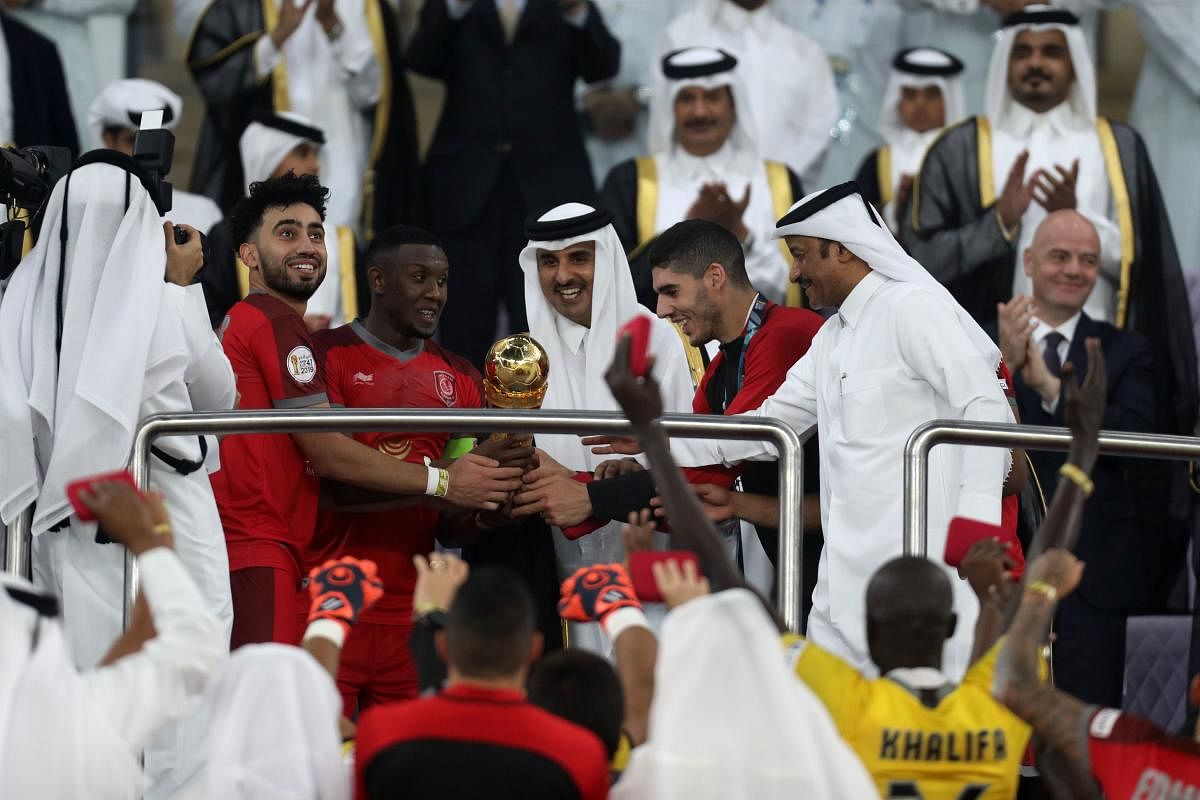 Qatar's Emir Tamim bin Hamad al-Thani (C) presents the trophy to the Duhail players following the Amir Cup final football match between Al Sadd and Al Duhail at the Al Wakrah Stadium in the Qatari city of Al Wakrah on May 16, 2019. (AFP)