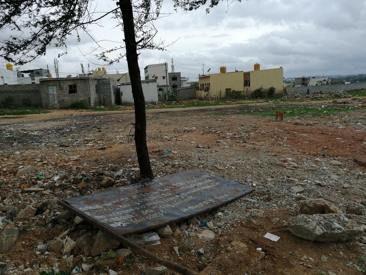The 2-acres 35 gunta revenue land in Subash Nagar, Begur ward, which has been flattened by the unknown people alleged for the formation of the sites. The government board which has been removed is also seen lying in the land. DH Photo Sandesh MS