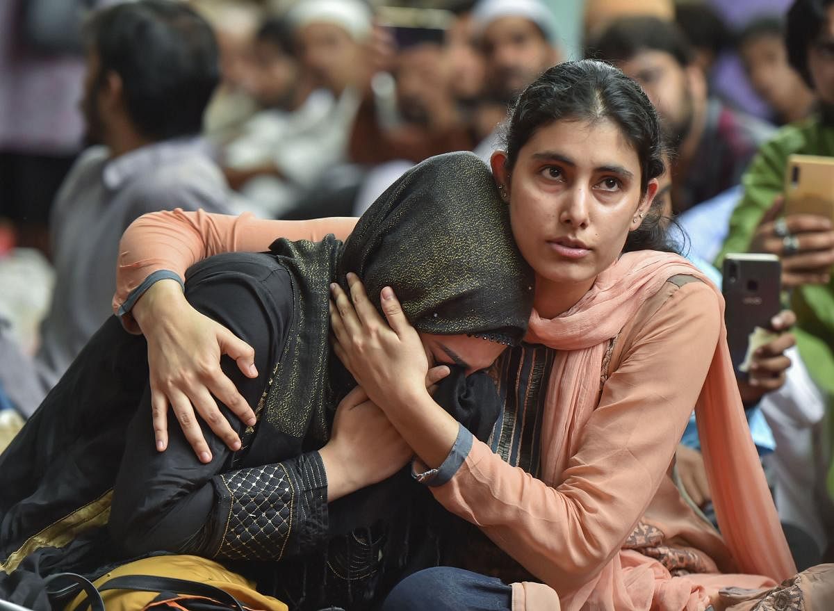 New Delhi: A Muslim woman gets emotional as she celebrates Eid with Kashmiri students who could not reach their families in the wake of abrogation of Article 370 in the state of Jammu and Kashmir, in New Delhi, Monday, Aug 12, 2019. (PTI Photo/Ravi Choudh