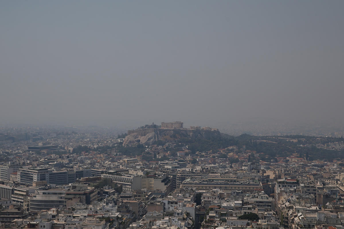 The Acropolis hill with the Parthenon temple is covered with smoke from a wildfire burning the Island of Evia, in Athens, Greece (Reuters photo)