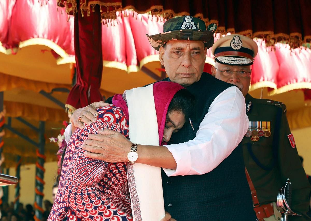  Union Home Minister, Rajnath Singh consoling Manu Sharma, wife of Late CT/GD Sanjeet Kumar, after presenting him with the President’s Police Medal for Gallantry (Posthumously), during the 54th Anniversary Parade of the Sashastra Seema Bal (SSB), in New Delhi on Saturday. Director General, SSB, Rajni Kant Mishra is also seen. PTI Photo / PIB for representation. 