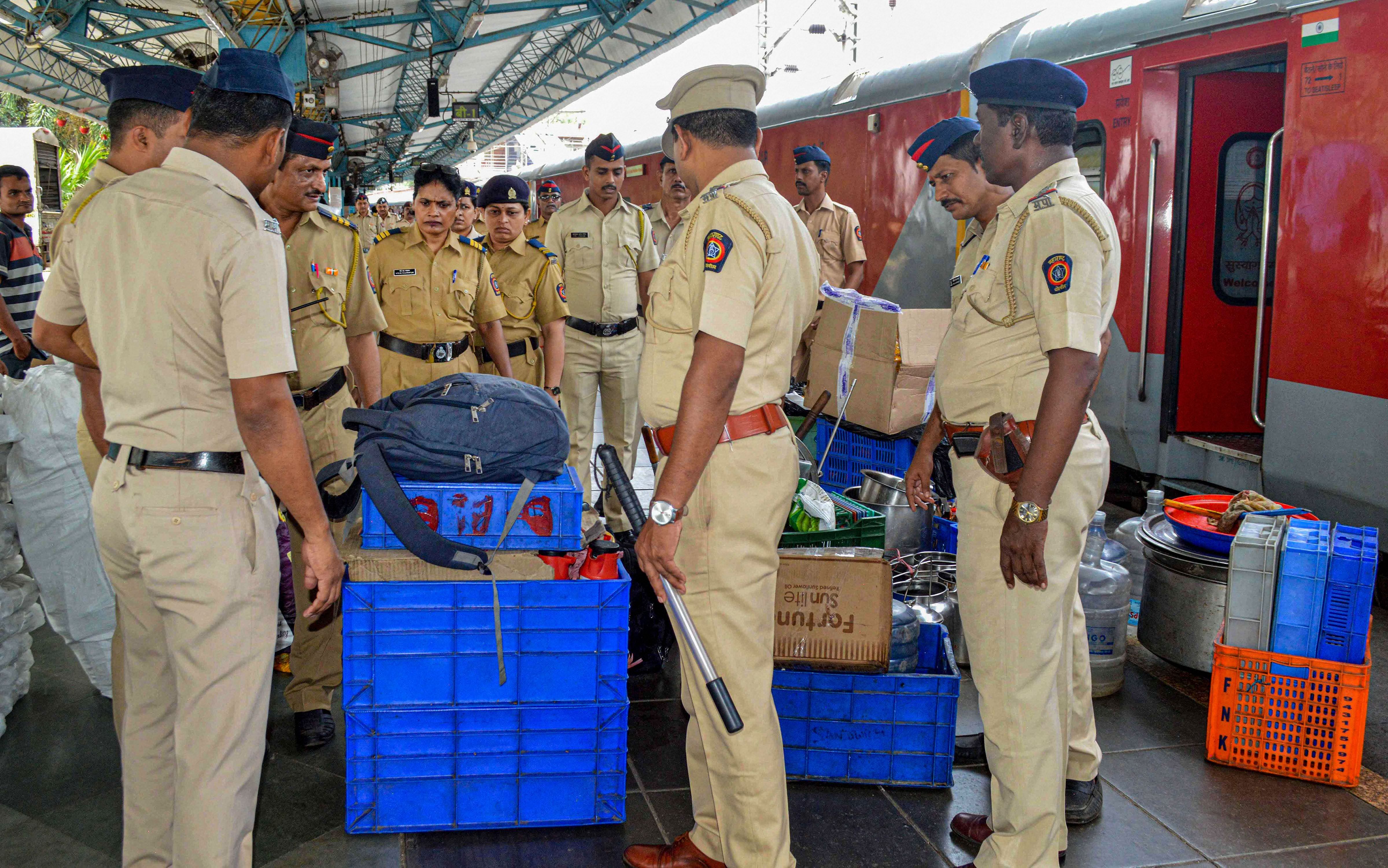 Railway police personnel check cartons, bags, utensils and other articles at Chhatrapati Shivaji Terminus, ahead of Independence Day (PTI Photo) 
