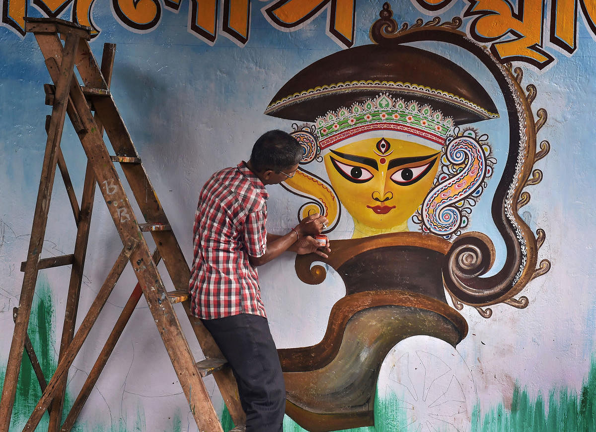 An artist paints a graffiti of Hindu goddess Durga on a wall, part of a campaign ahead of upcoming Durga Puja festival, in Kolkata, on August 13, 2019. PTI
