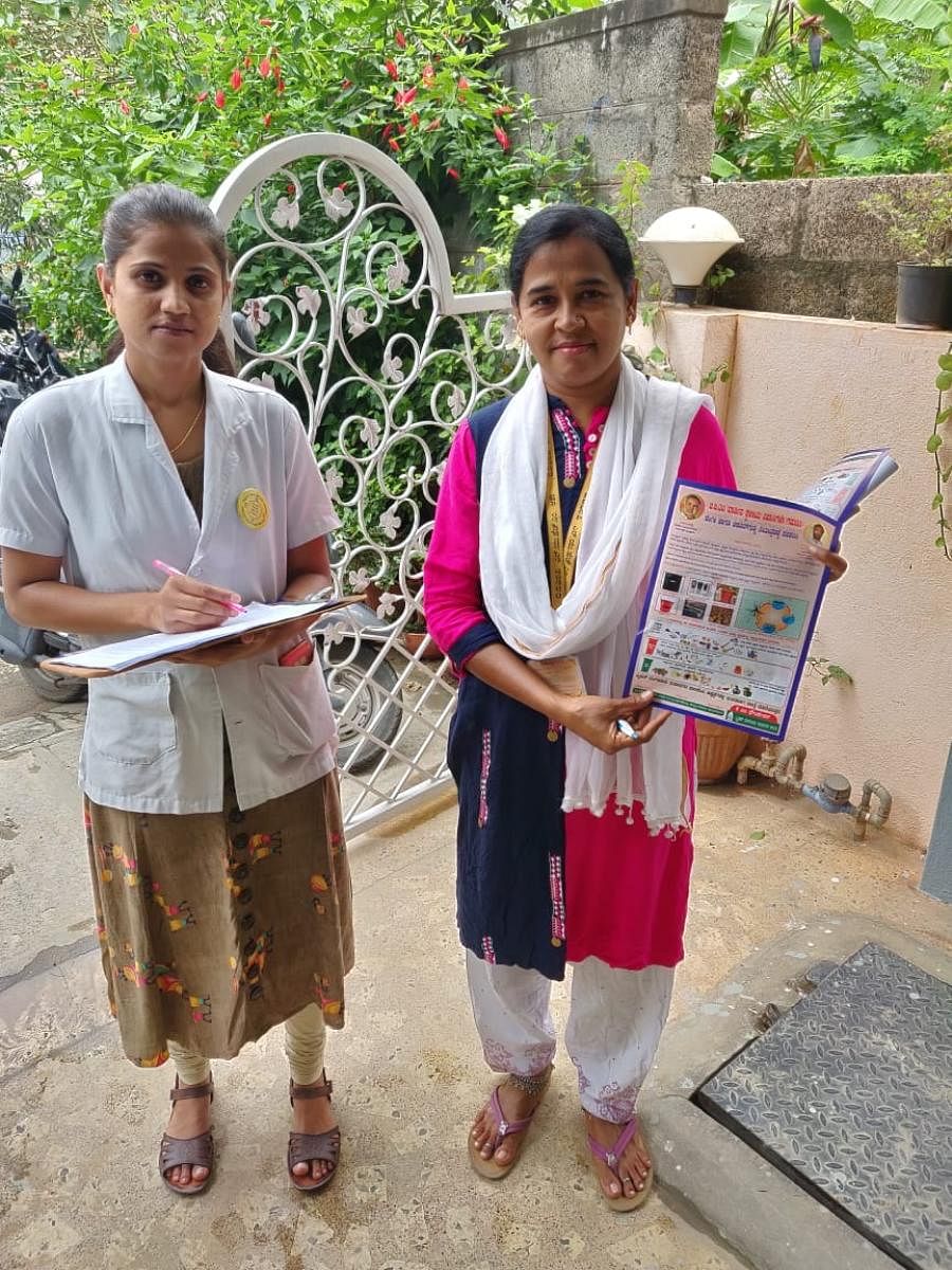 Asha and ANM during a door-to-door awareness campaign.