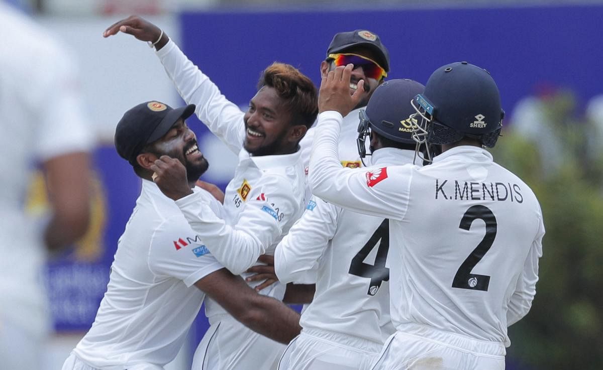 Sri Lanka's Akila Dananjaya (second from left) celebrates after taking the wicket of New Zealand's Kane Williamson. AP/PTI